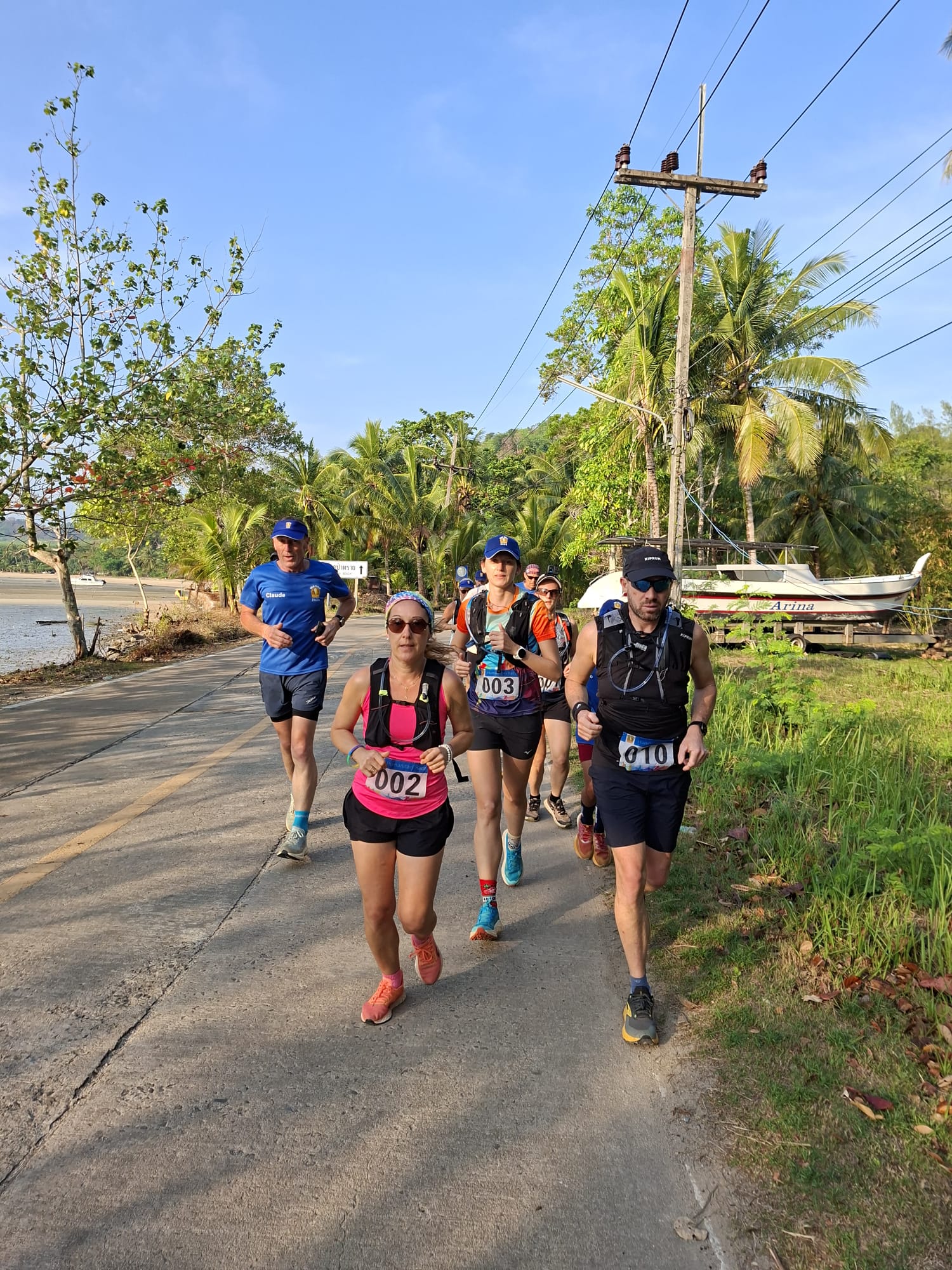 Participants de Wai Tchai Run courant en Thaïlande dans un paysage tropical